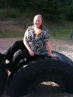 Kari sitting on a tire
