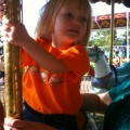 Kaitlyn riding the merry-go-round at the fair