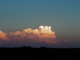 Closer view of distant thunderstorm at sunset.