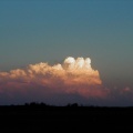 Closer view of distant thunderstorm at sunset.